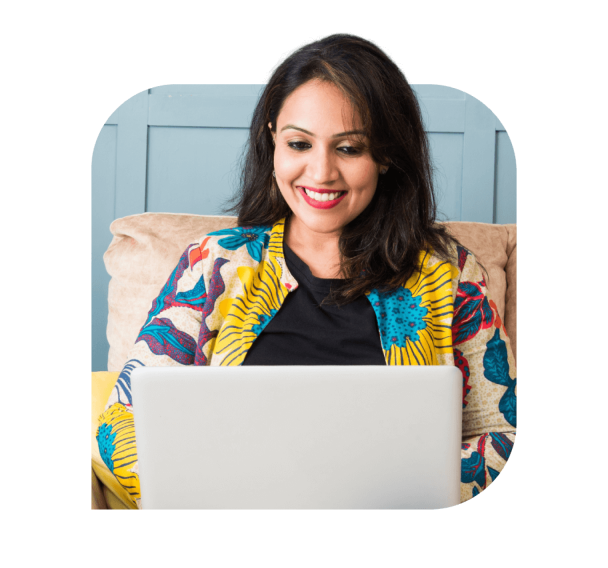 A woman working on laptop with the smile on her face